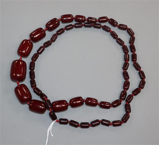 A single strand graduated simulated dark cherry amber necklace, gross weight, 98 grams,